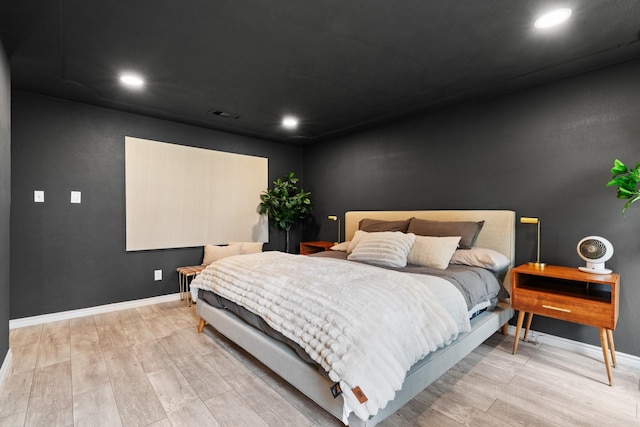 bedroom with recessed lighting, wood finished floors, visible vents, and baseboards