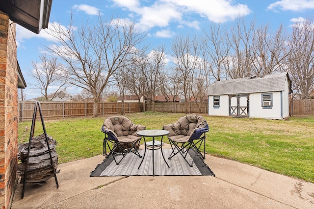 view of patio featuring an outbuilding, a fenced backyard, and a storage unit