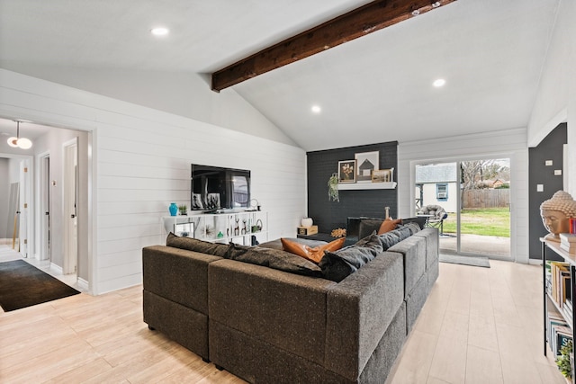 living area with recessed lighting, lofted ceiling with beams, and light wood finished floors