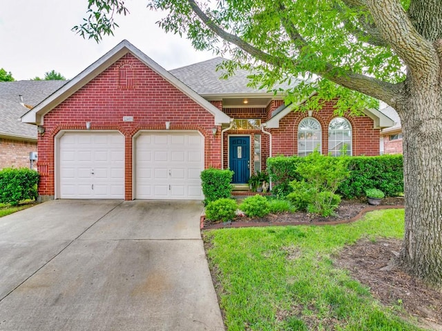 3605 Kales Ln, Flower Mound, TX 75022 - view of front of home with roof with shingles, an attached garage, concrete driveway, and brick siding