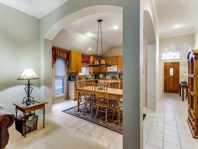 3605 Kales Ln, Flower Mound, TX 75022 - living area with crown molding, visible vents, light carpet, ceiling fan, and arched walkways