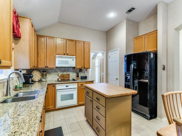 3605 Kales Ln, Flower Mound, TX 75022 - kitchen with lofted ceiling, a toaster, a sink, light tile patterned floors, and black appliances