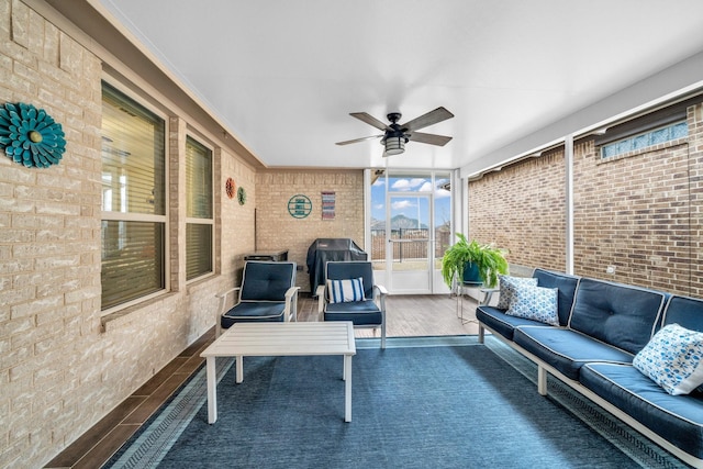 sunroom / solarium featuring a ceiling fan