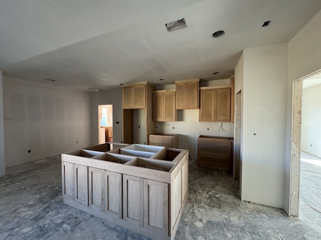 kitchen featuring light brown cabinetry and a center island