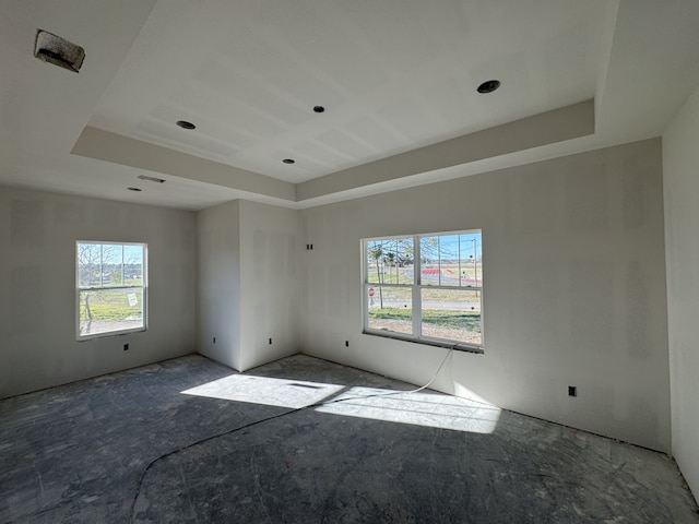 unfurnished room with a tray ceiling