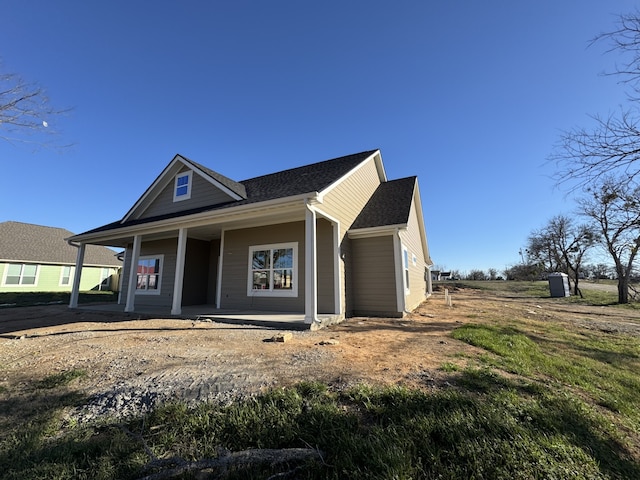 view of front of house featuring a porch and roof with shingles