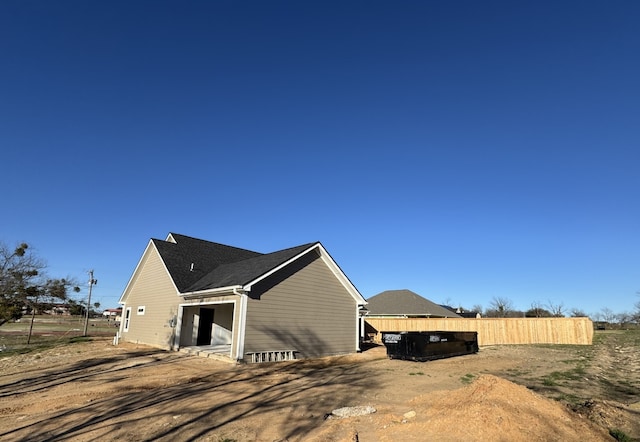 view of home's exterior with fence