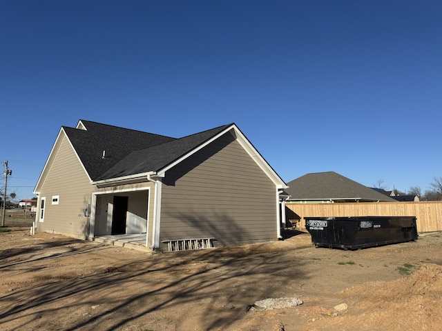 view of side of property featuring fence