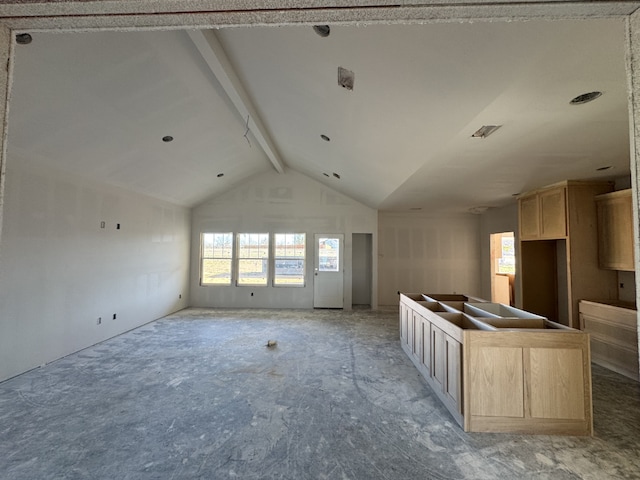 kitchen featuring a center island, open floor plan, vaulted ceiling with beams, and light brown cabinetry