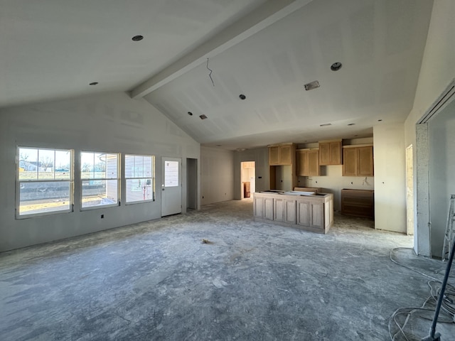 unfurnished living room with high vaulted ceiling and beam ceiling