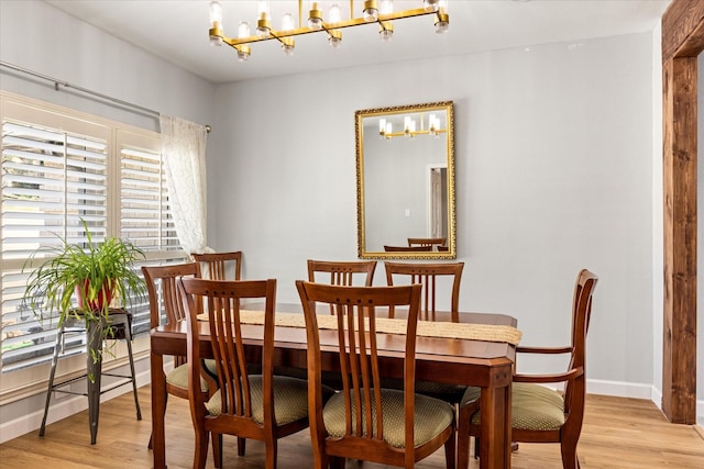 4105 Cimmaron Trl, Granbury, TX 76049 - dining room with a chandelier, light wood-style flooring, and baseboards