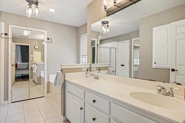 4105 Cimmaron Trl, Granbury, TX 76049 - full bathroom featuring double vanity, tile patterned floors, baseboards, a shower with shower door, and recessed lighting