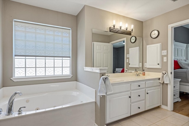 4105 Cimmaron Trl, Granbury, TX 76049 - full bathroom with double vanity, ensuite bath, a tub with jets, tile patterned floors, and baseboards
