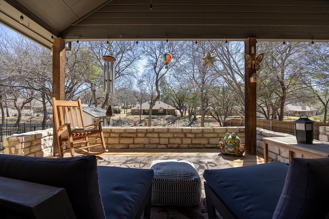 view of patio with an outdoor living space and fence