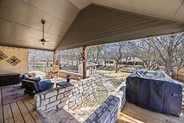 wooden terrace featuring area for grilling, a ceiling fan, and fence