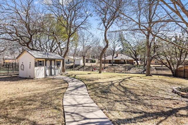 view of yard featuring a storage unit, fence private yard, and an outdoor structure