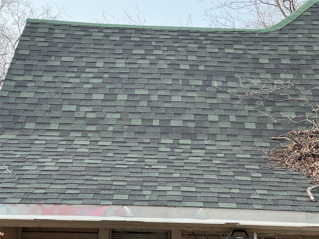 exterior details featuring a shingled roof