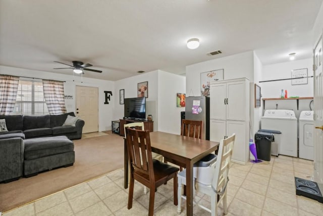 dining room with washing machine and clothes dryer, visible vents, and a ceiling fan