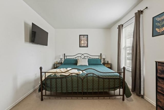 carpeted bedroom featuring baseboards