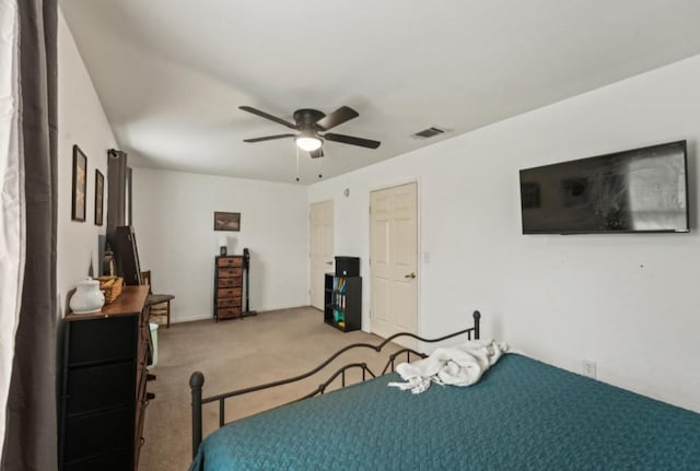 carpeted bedroom with visible vents and a ceiling fan