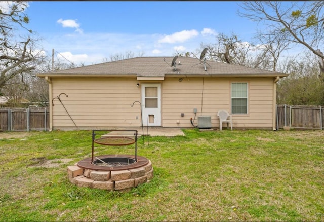 back of property featuring an outdoor fire pit, a lawn, a fenced backyard, and a patio