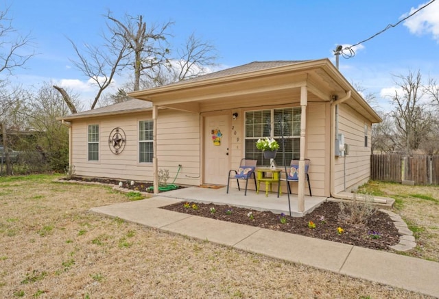 bungalow-style house with fence and a front yard