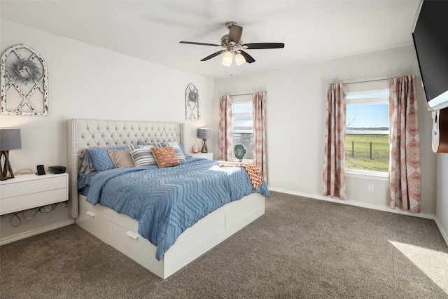 carpeted bedroom featuring ceiling fan, multiple windows, and baseboards