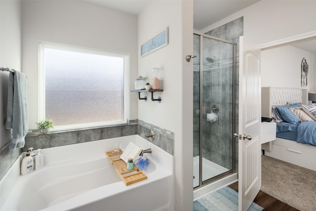 ensuite bathroom with a stall shower, a garden tub, and connected bathroom