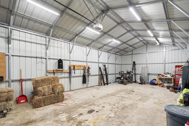 garage featuring a garage door opener and metal wall