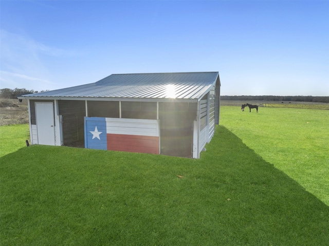 view of outdoor structure featuring an outbuilding and a rural view