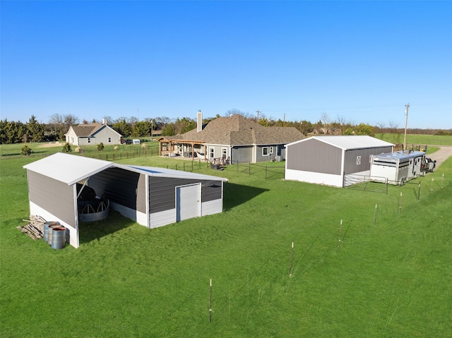 exterior space with an outbuilding, a pole building, and fence