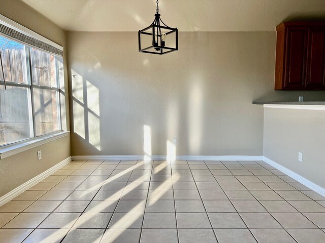 2436 Castle Pines Dr, Burleson, TX 76028 - unfurnished dining area with light tile patterned floors, baseboards, and a chandelier