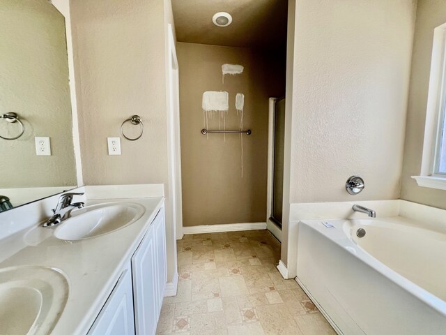2436 Castle Pines Dr, Burleson, TX 76028 - full bathroom featuring a garden tub, double vanity, a sink, and baseboards