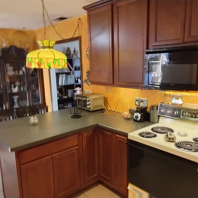 kitchen featuring visible vents, a peninsula, a toaster, electric stove, and black microwave