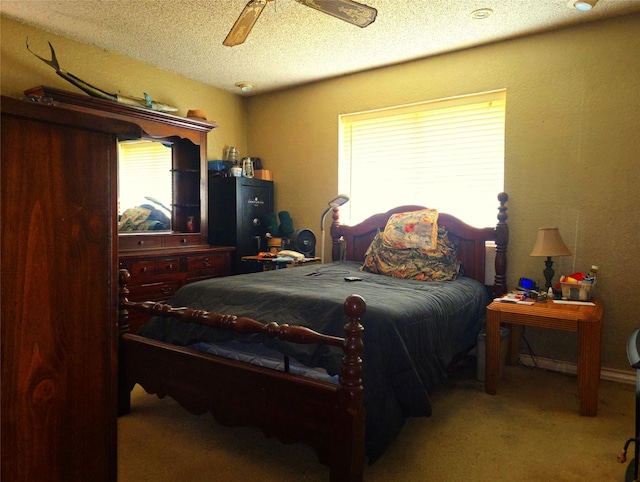 carpeted bedroom with a ceiling fan and a textured ceiling