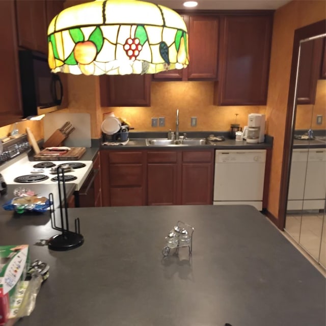 kitchen featuring range with electric cooktop, a sink, black microwave, dishwasher, and dark countertops