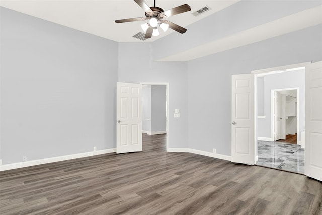 unfurnished bedroom featuring visible vents, ceiling fan, baseboards, and wood finished floors