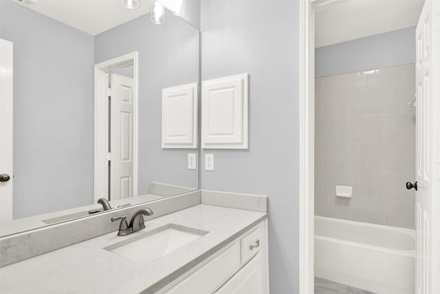 bathroom featuring  shower combination, marble finish floor, and vanity