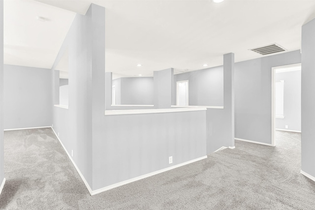 corridor featuring recessed lighting, carpet flooring, visible vents, and baseboards