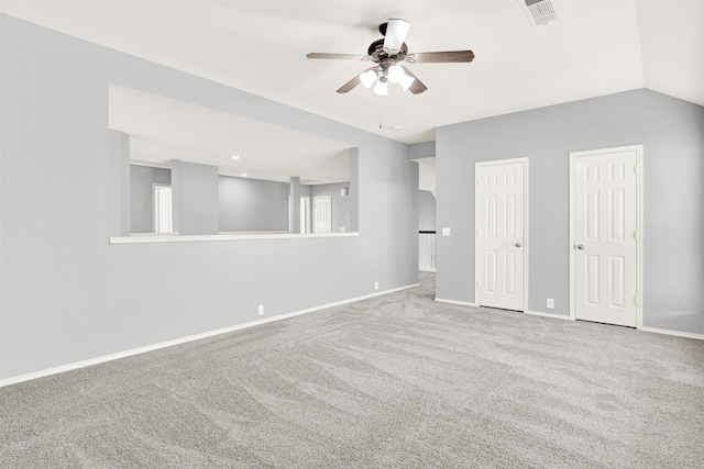 carpeted spare room featuring lofted ceiling, visible vents, ceiling fan, and baseboards