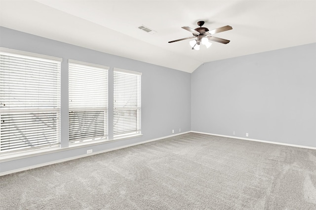 unfurnished room featuring vaulted ceiling, ceiling fan, carpet, and visible vents