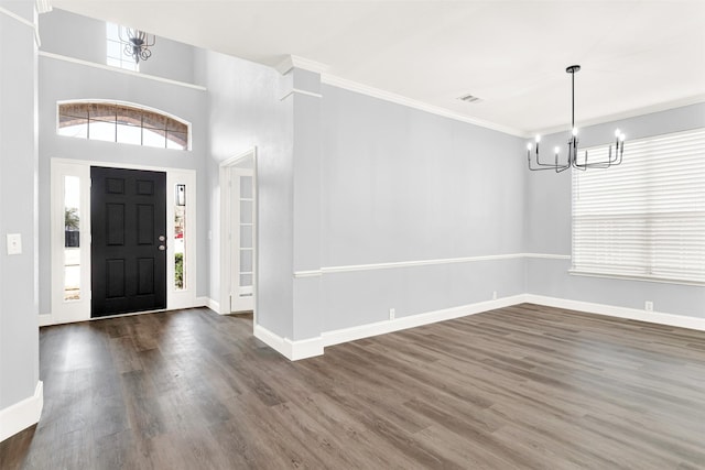 entrance foyer with crown molding, dark wood-style flooring, and plenty of natural light