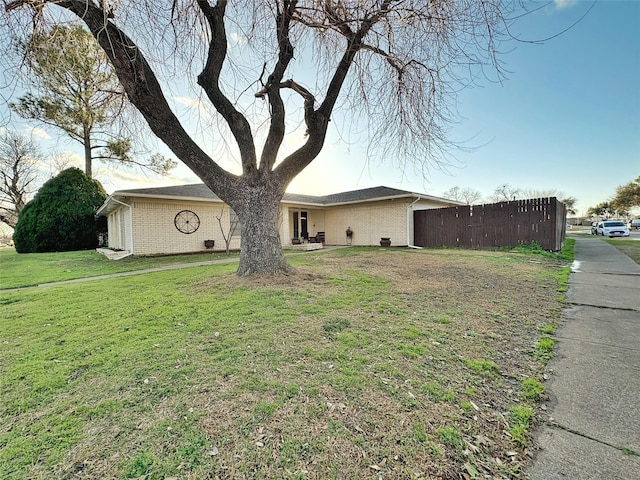 exterior space featuring a front lawn and brick siding