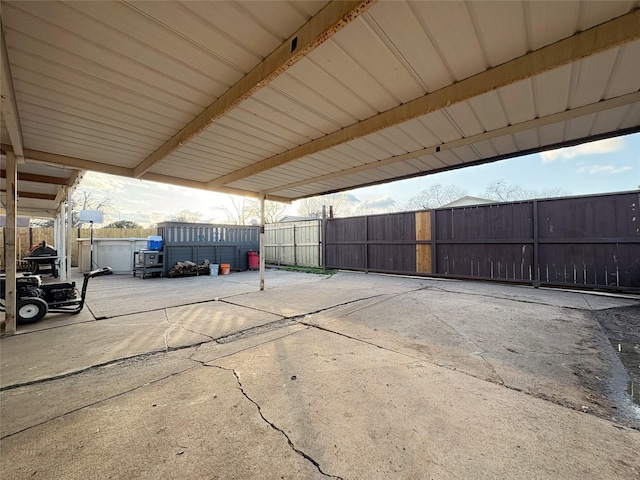 exterior space with fence and a carport