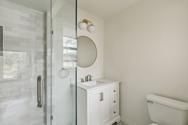 full bath featuring a stall shower, toilet, and vanity