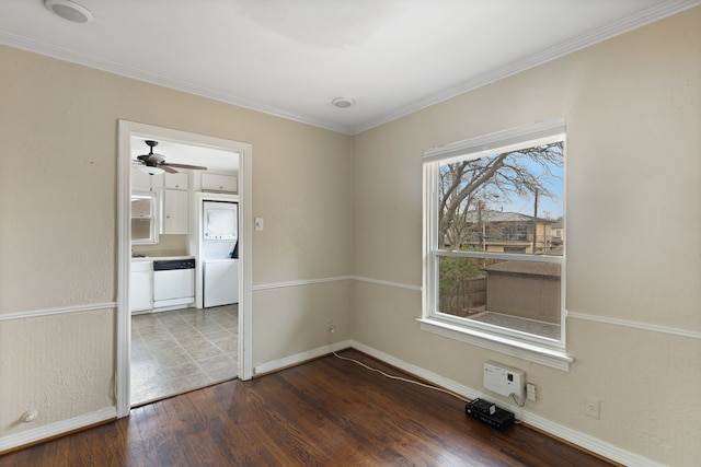 empty room with crown molding, dark wood-style floors, and baseboards