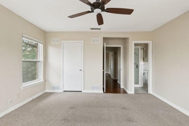 unfurnished bedroom featuring carpet and visible vents