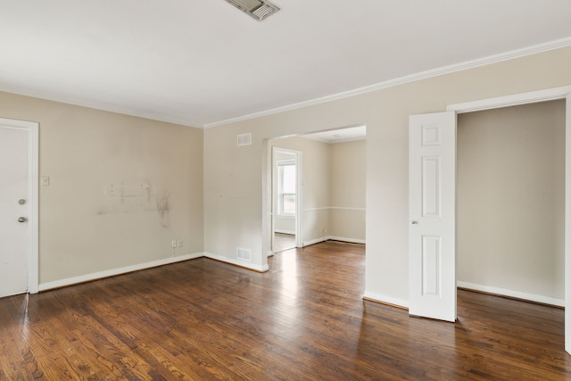 empty room with wood finished floors and visible vents