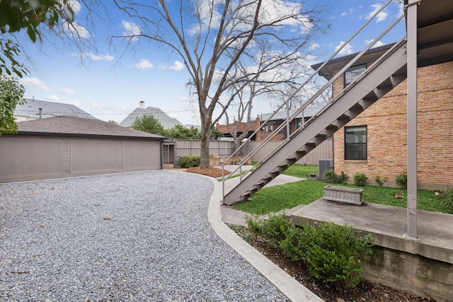 view of yard featuring stairway and fence