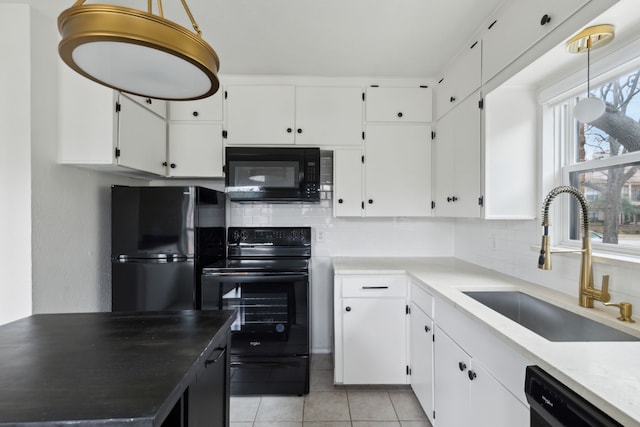 kitchen with a sink, tasteful backsplash, black appliances, and white cabinetry